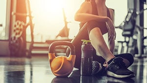 Young woman resting on floor during workout